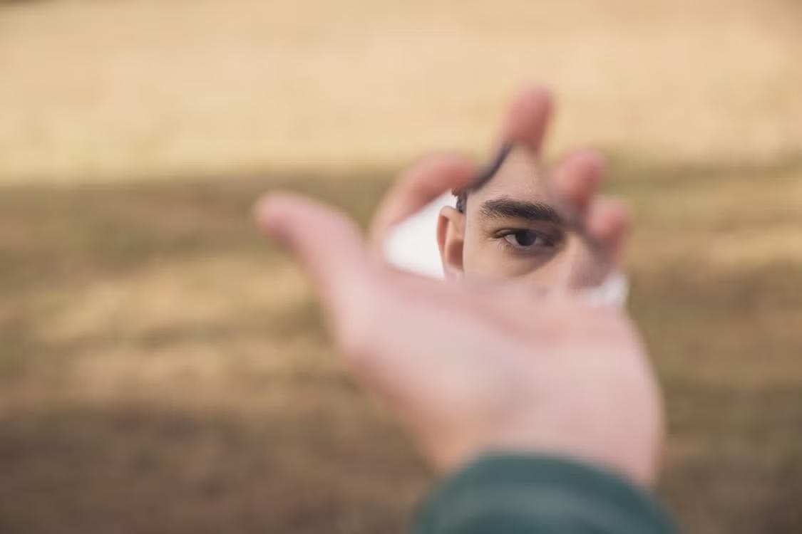 a person looking into a broken mirror